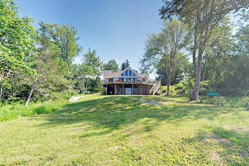 Renovated waterfront cottage with expansive deck, multiple fireplaces, & grill